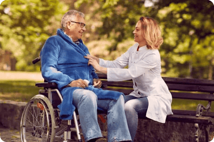 Man in wheel chair with carer