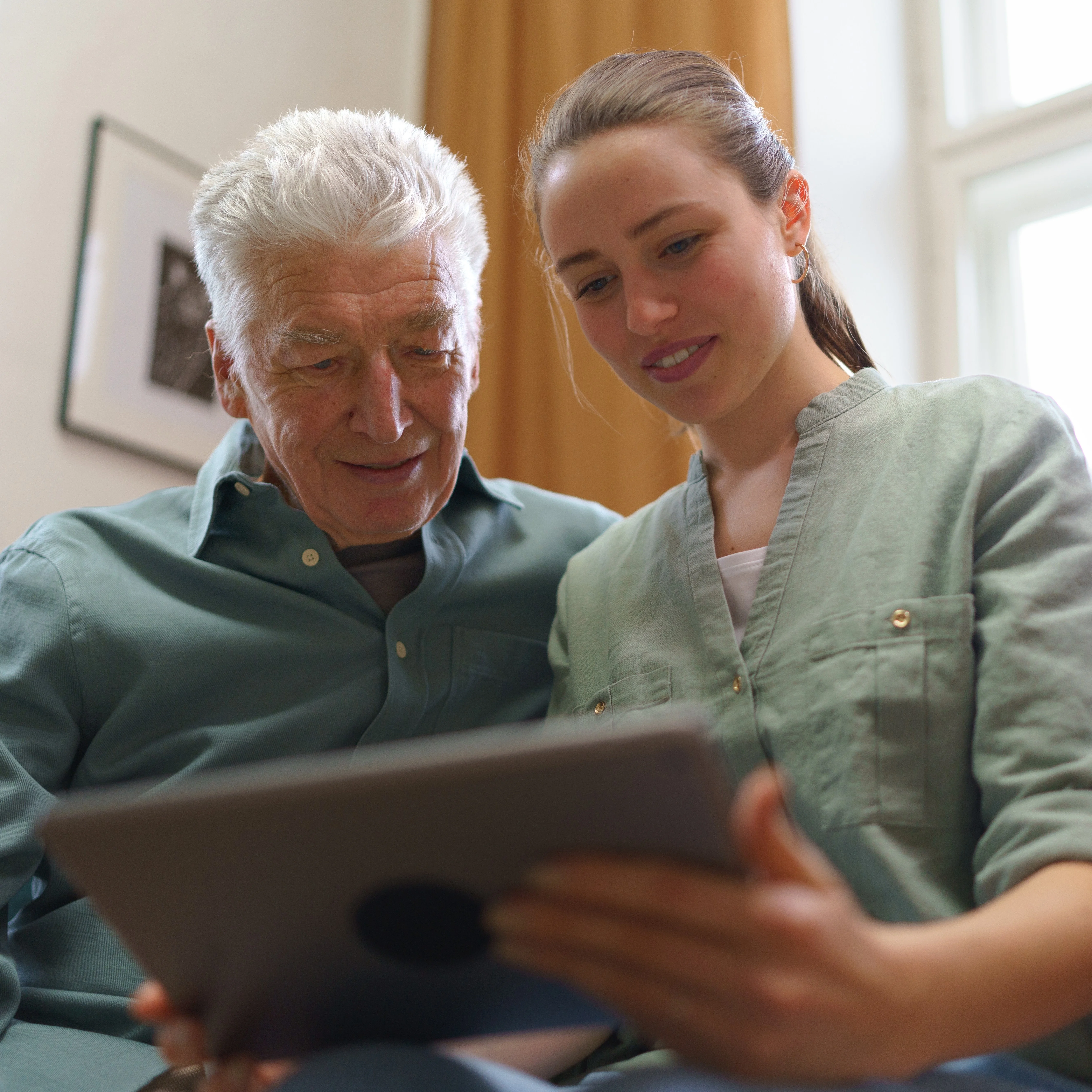 elderly man and carer looking at care plan
