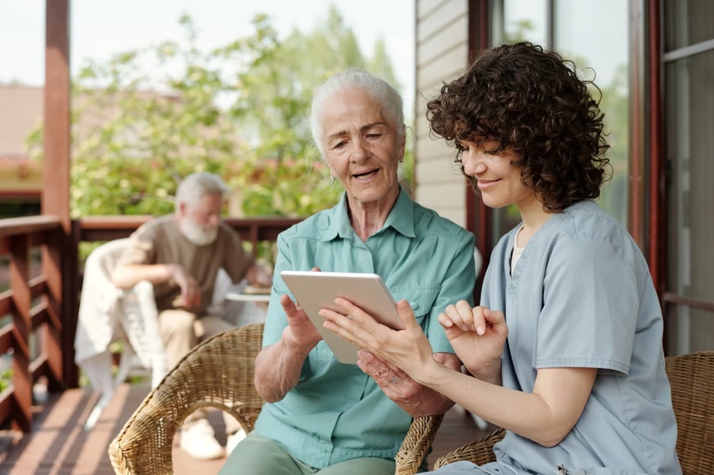 elderly woman and carer looking at care plan