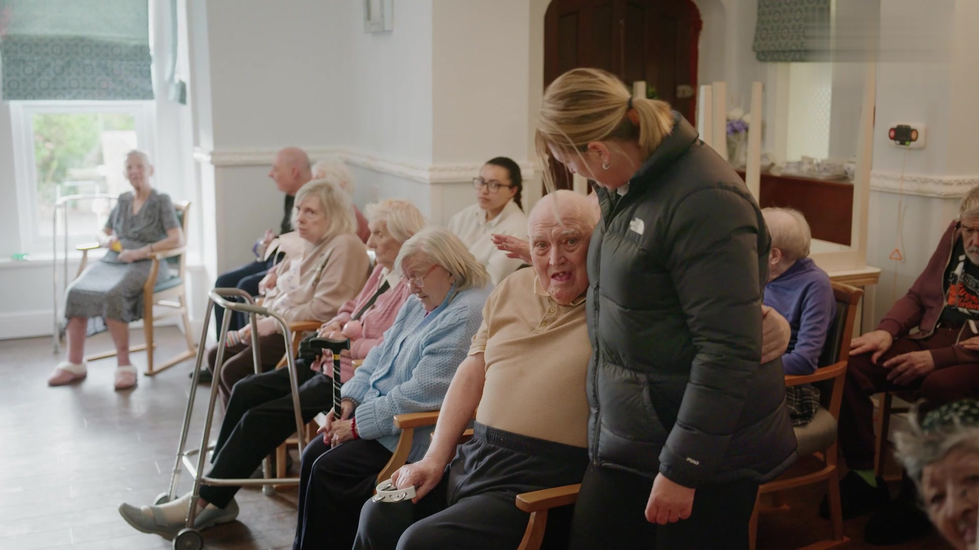 Residents get ready to join an activity with a carer
