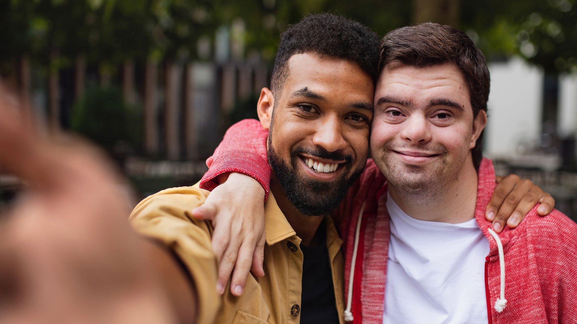 Young man with Downs smiles with his mentor
