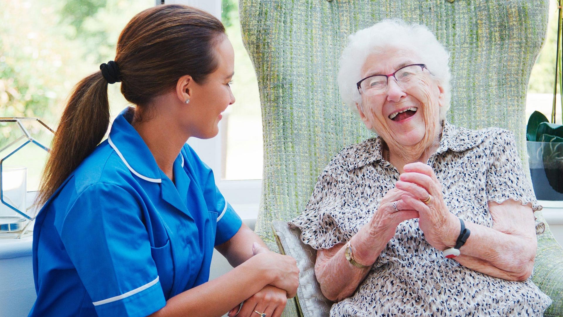 Carer laughing with a resident