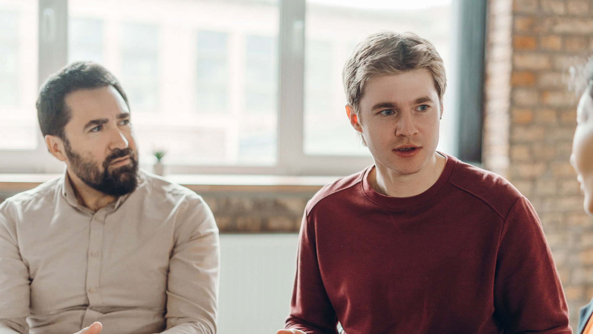 Young man talking in a group therapy session