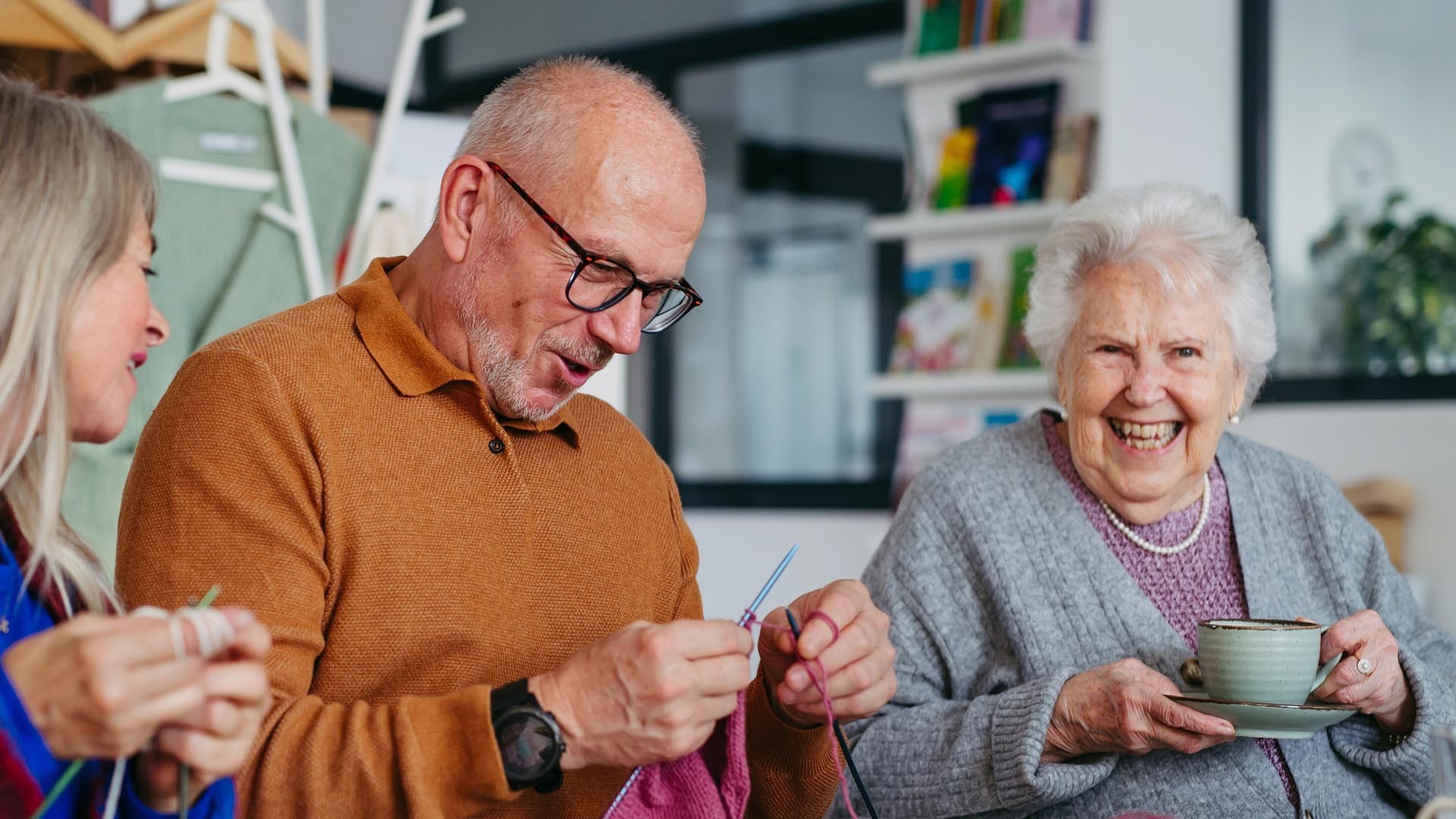 Residents participate in a knitting class with a teacher