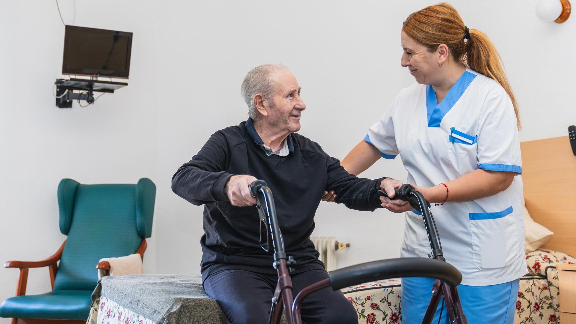Nurse helps a resident with his walker