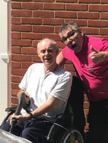 the-care-workers-charity-patient-in-wheelchair-and-carer-stood-behind